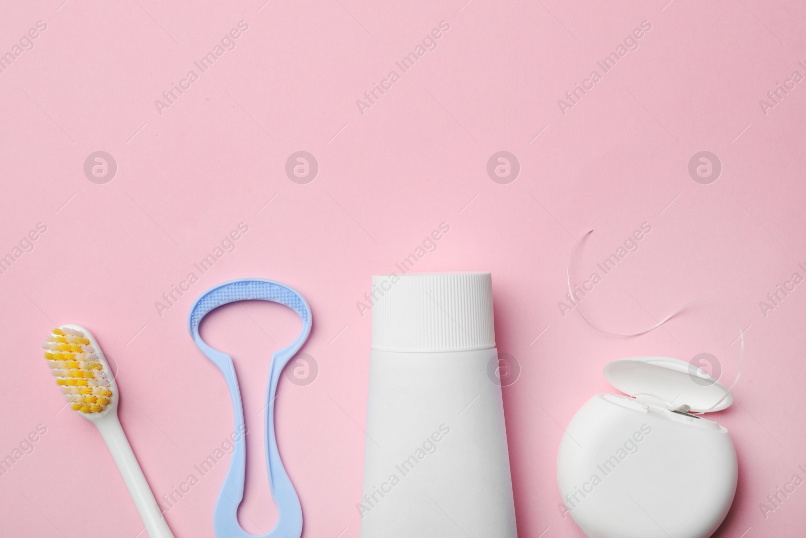 Photo of Flat lay composition with tongue cleaner and teeth care products on color background. Space for text