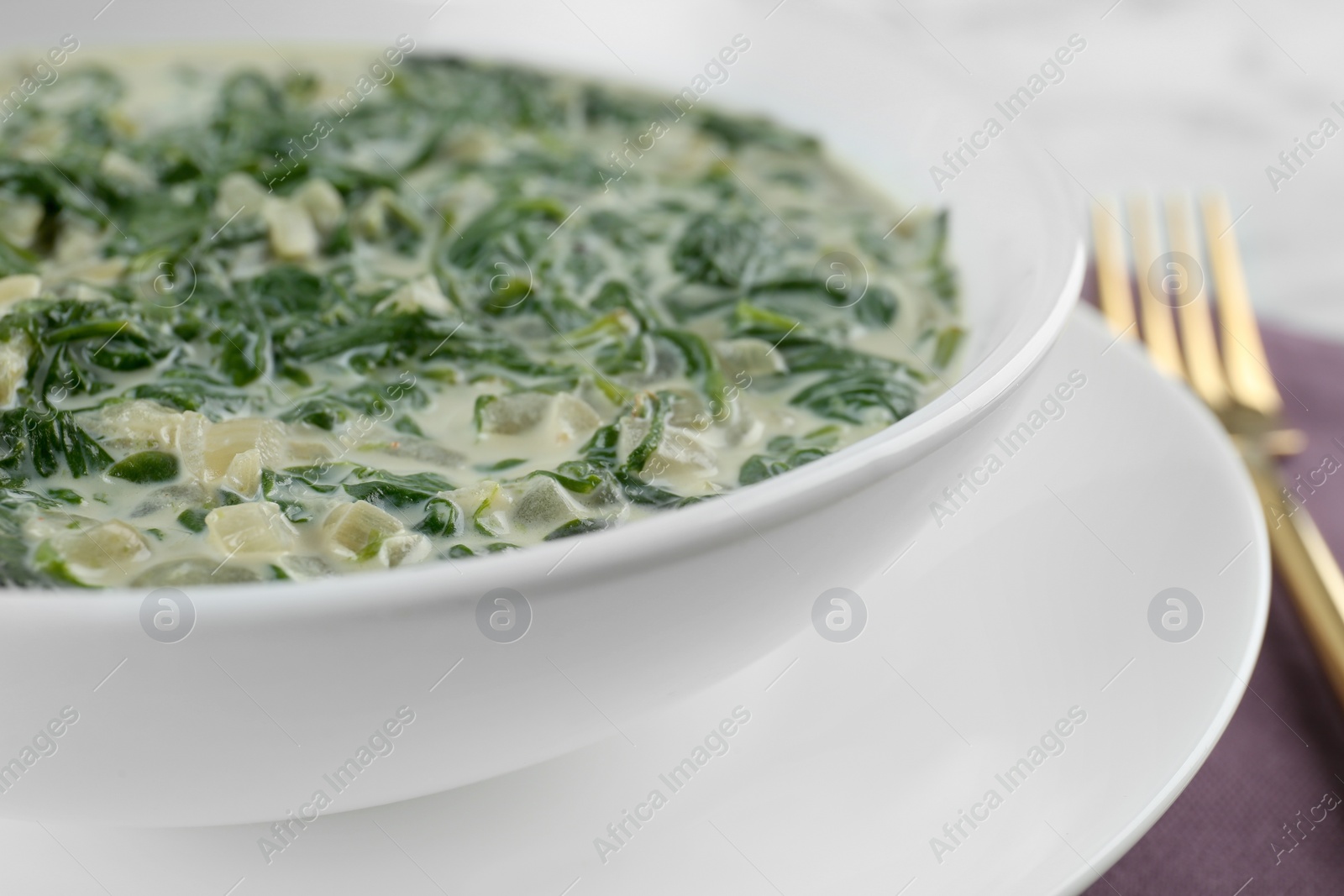 Photo of Tasty spinach dip in white ceramic bowl