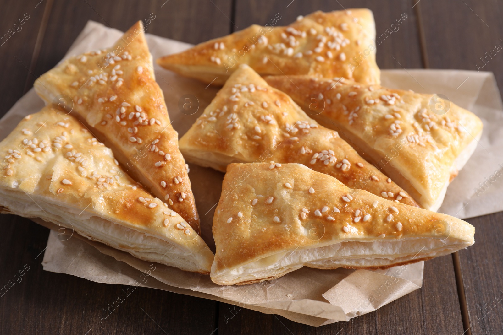 Photo of Delicious puff pastry on wooden table, closeup