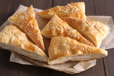 Delicious puff pastry on wooden table, closeup