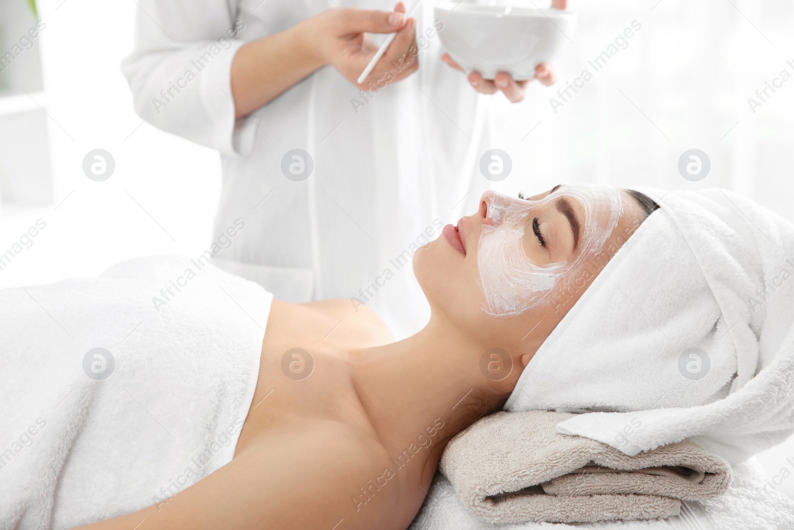 Photo of Pretty woman with mask on her face in spa salon