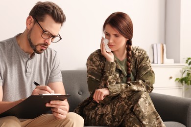 Psychologist working with female military officer in office