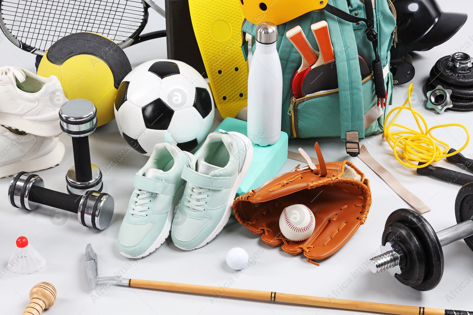 Photo of Many different sports equipment on light grey background