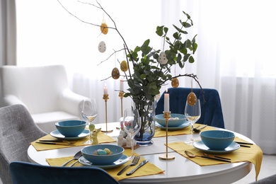 Photo of Beautiful Easter table setting with festive decor indoors