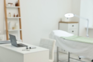 Photo of Modern interior of dermatologist's office with examination table