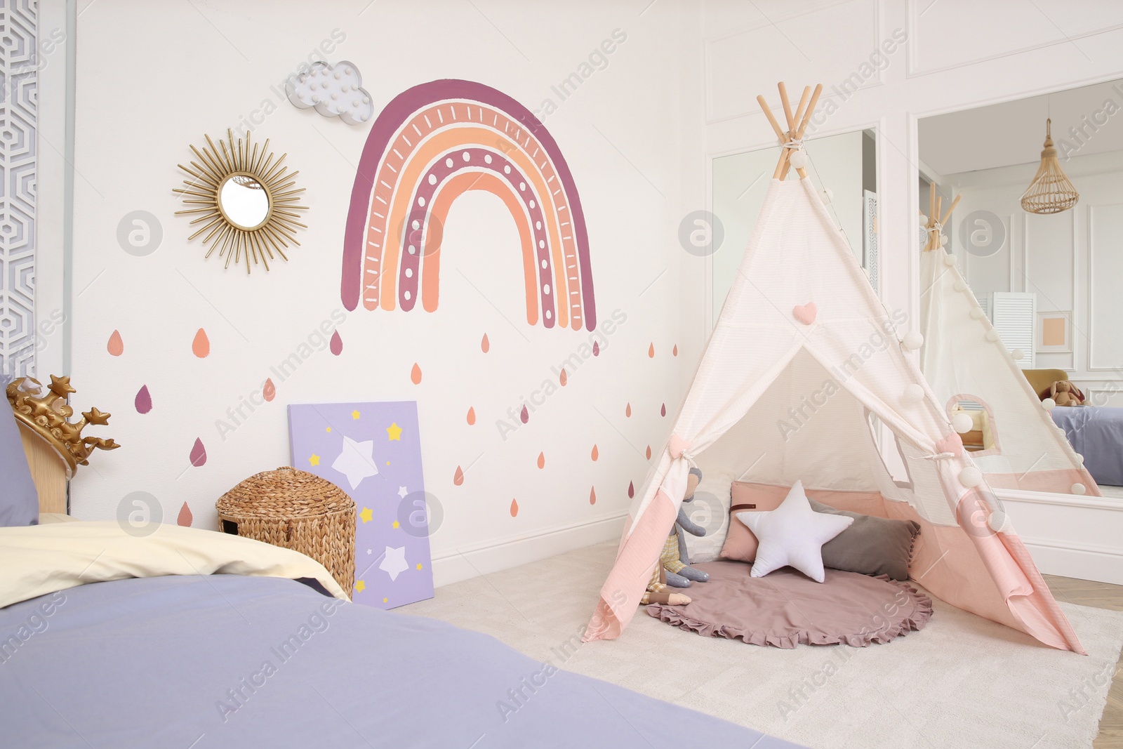 Photo of Stylish room with comfortable bed and teepee tent for kids. Interior design