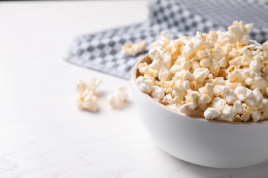 Photo of Delicious popcorn corn on light table, closeup