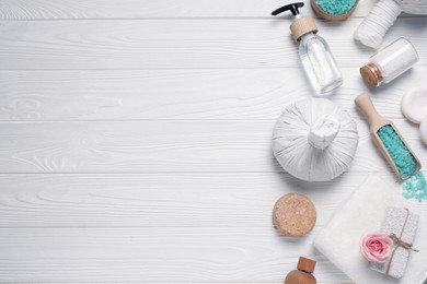Photo of Flat lay composition of herbal bags and spa products on white wooden table, space for text