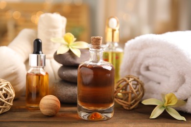 Photo of Beautiful spa composition with essential oil on wooden table against blurred lights
