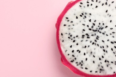 Delicious cut dragon fruit (pitahaya) on pink background, closeup. Space for text