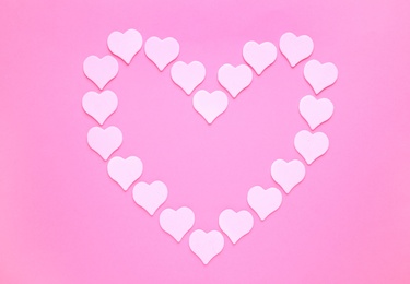 Photo of Heart shaped frame on pink background, flat lay. Space for text