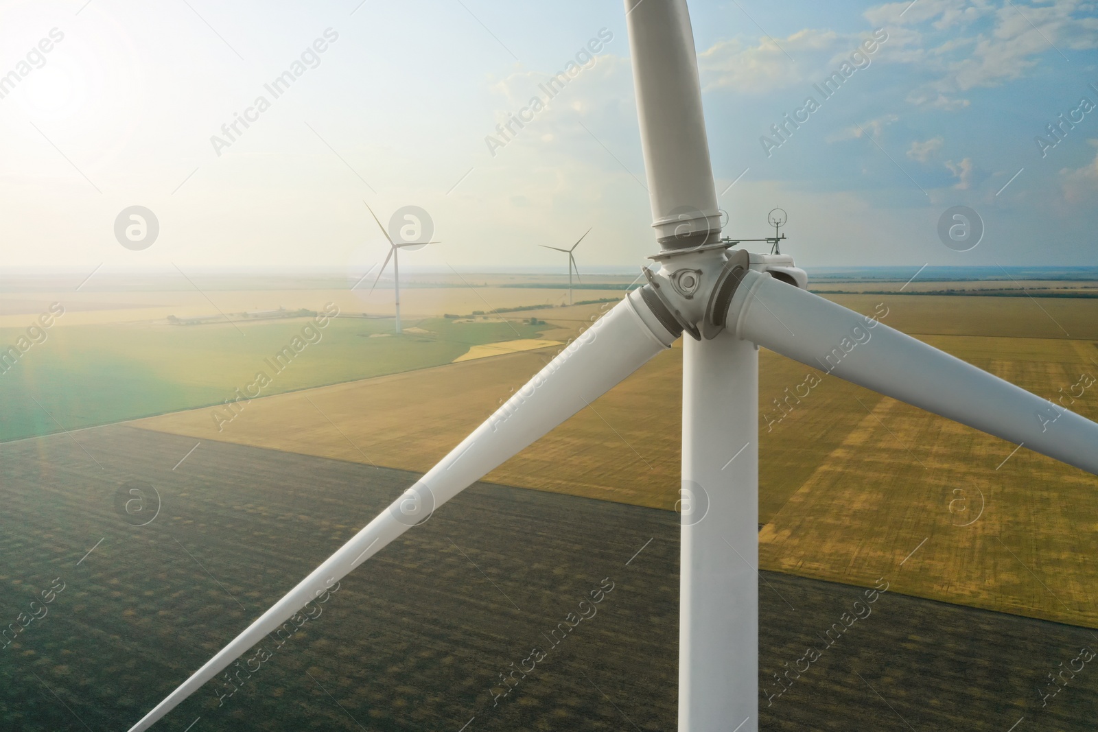 Photo of Modern windmill in field, closeup. Energy efficiency