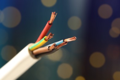 Photo of Cable with copper wires against blurred background, closeup