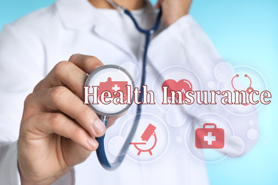 Image of Phrase Health Insurance, icons and doctor with stethoscope on light blue background, closeup