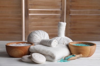 Spa composition with skin care products on white wooden table