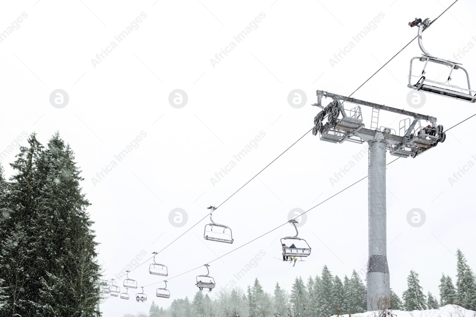 Photo of Ski lift at mountain resort. Winter vacation