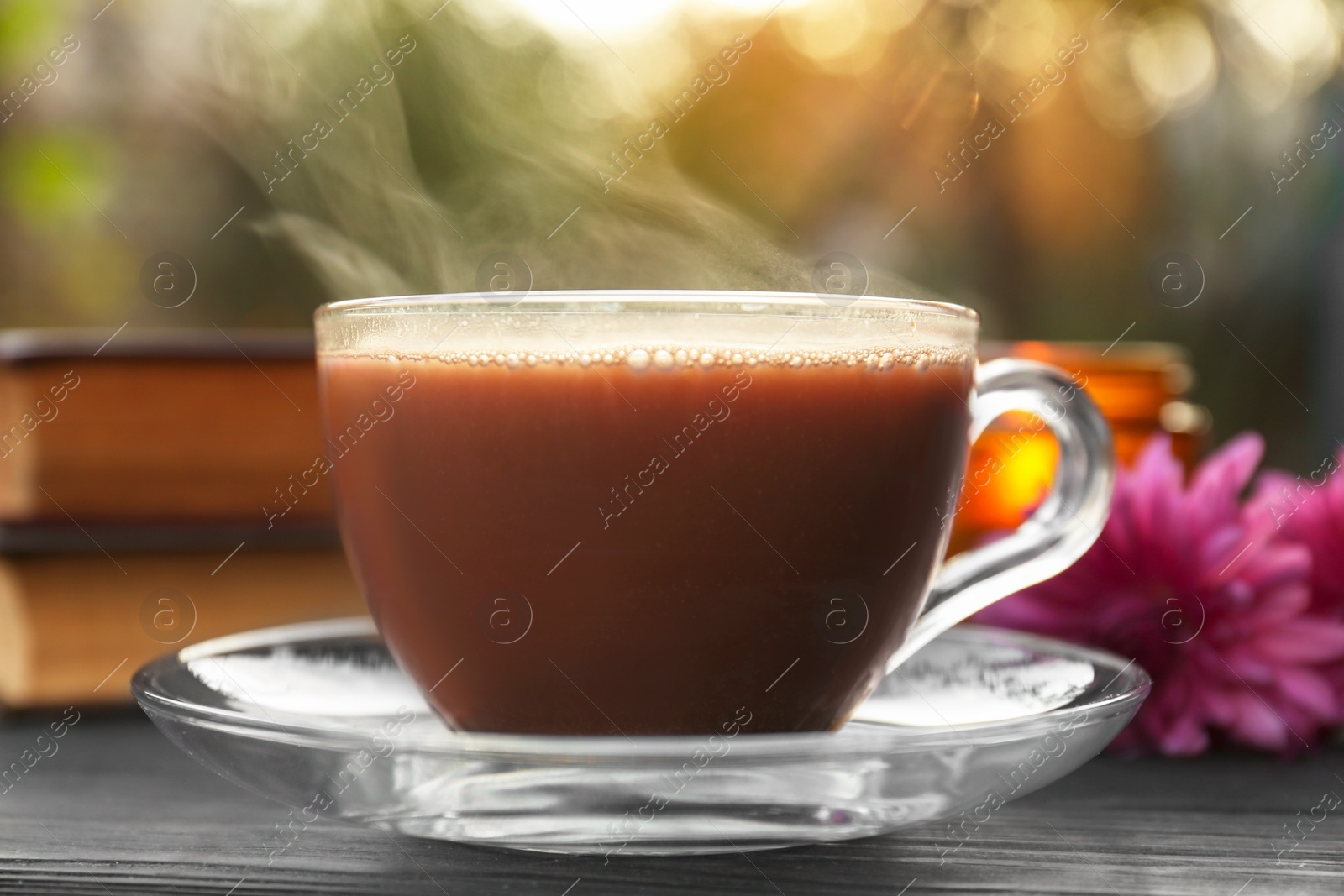 Photo of Glass cup with coffee on wooden table, closeup. Morning ritual