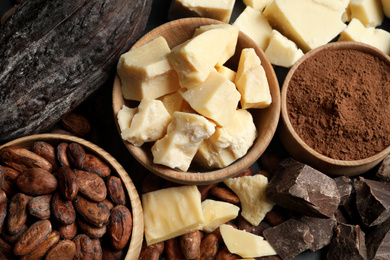 Photo of Composition with organic cocoa butter on black table, flat lay