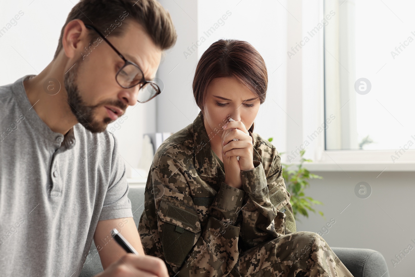 Photo of Psychologist working with female military officer in office