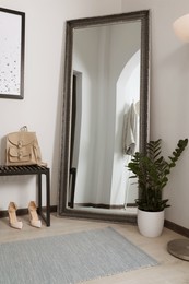 Photo of Modern hallway interior with large mirror and houseplant