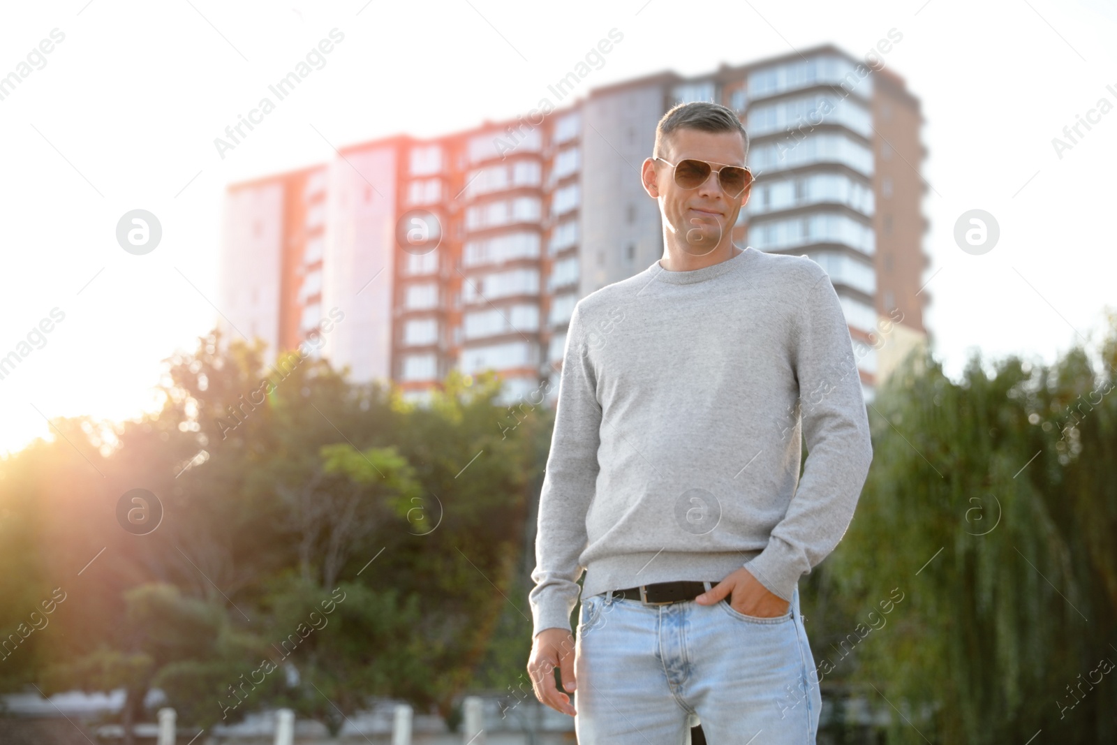 Photo of Man in stylish sweater on city street