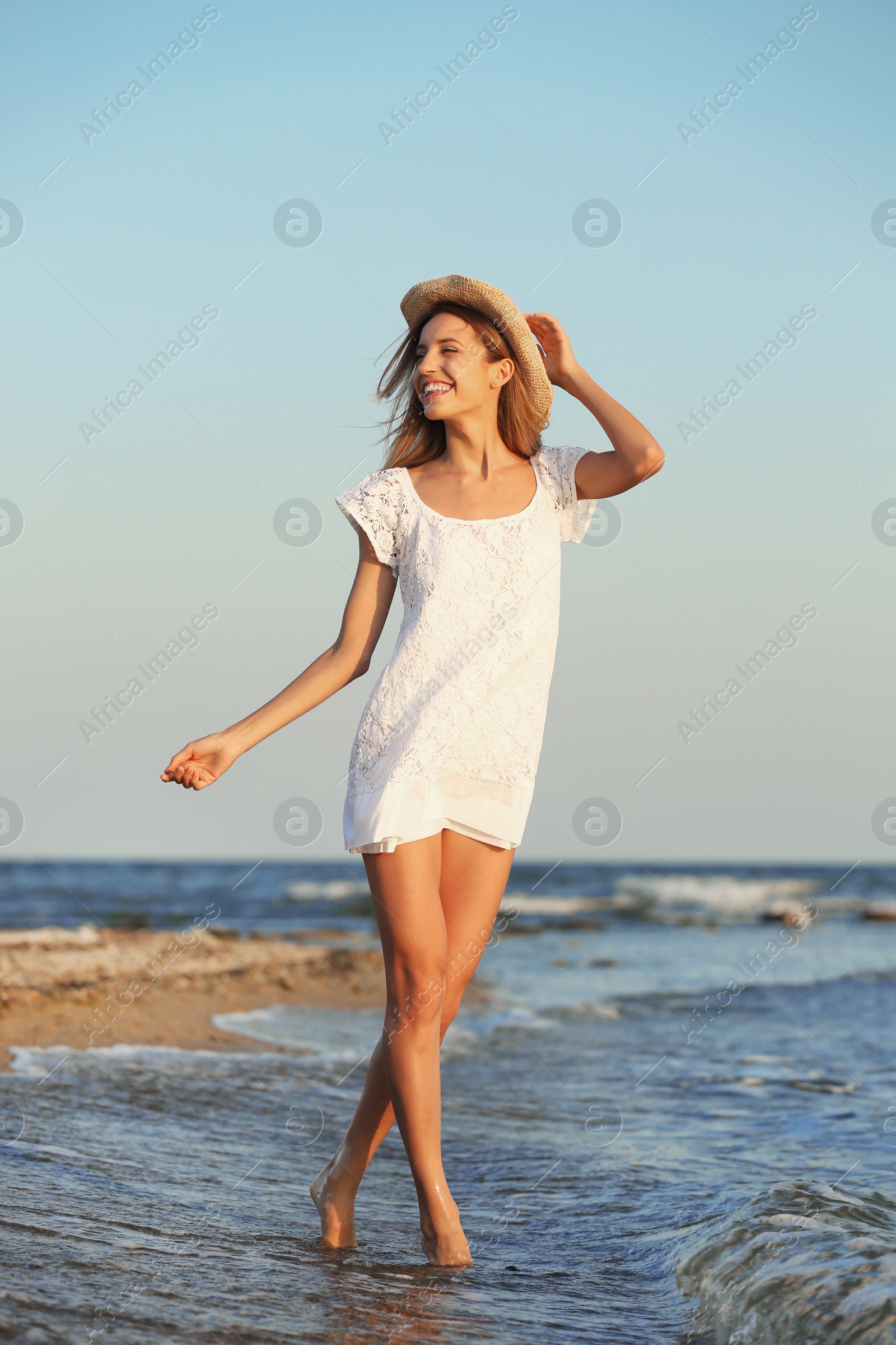 Photo of Young woman enjoying sunny day on beach