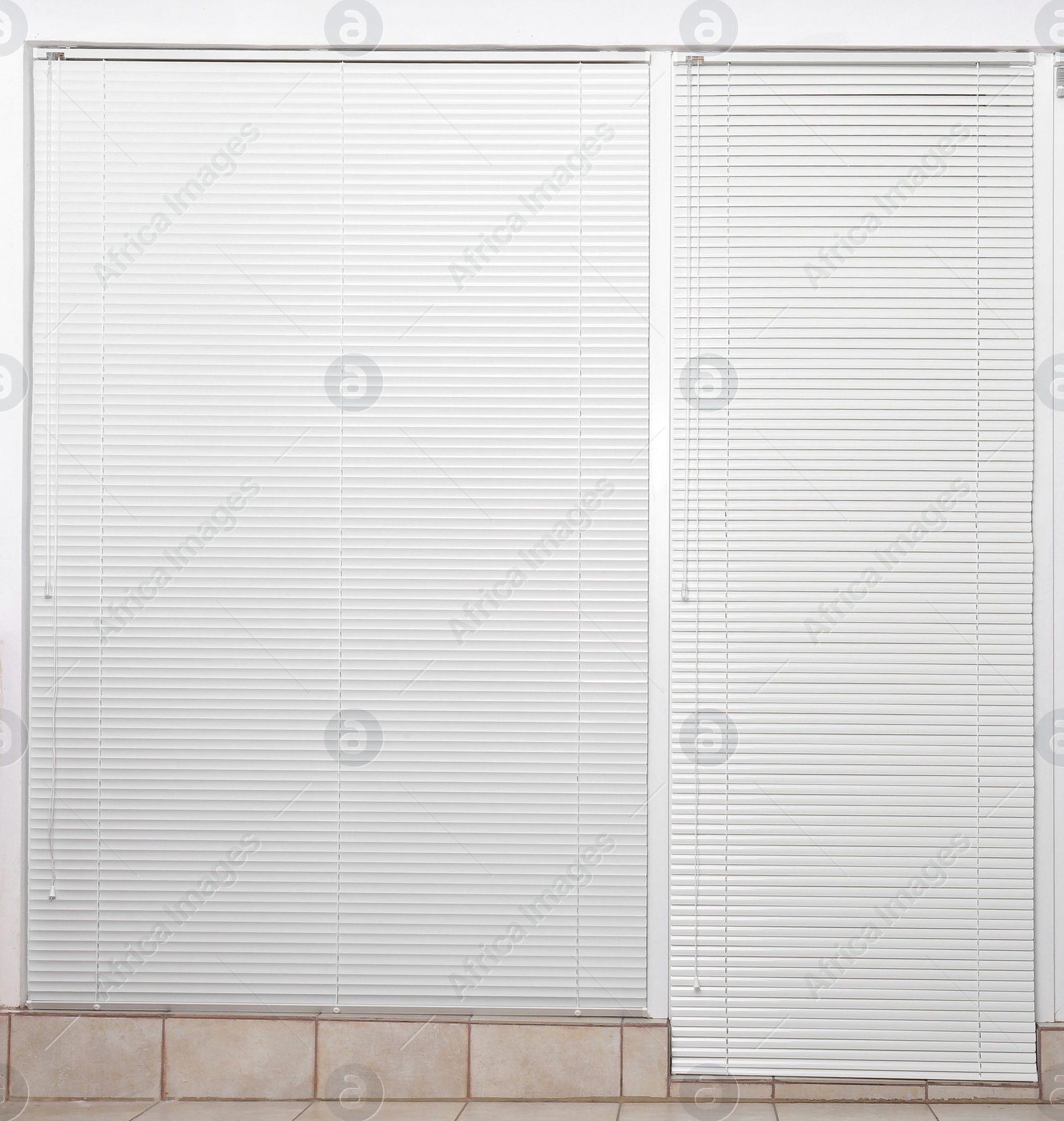 Photo of Window with closed white horizontal blinds indoors