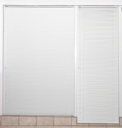 Photo of Window with closed white horizontal blinds indoors