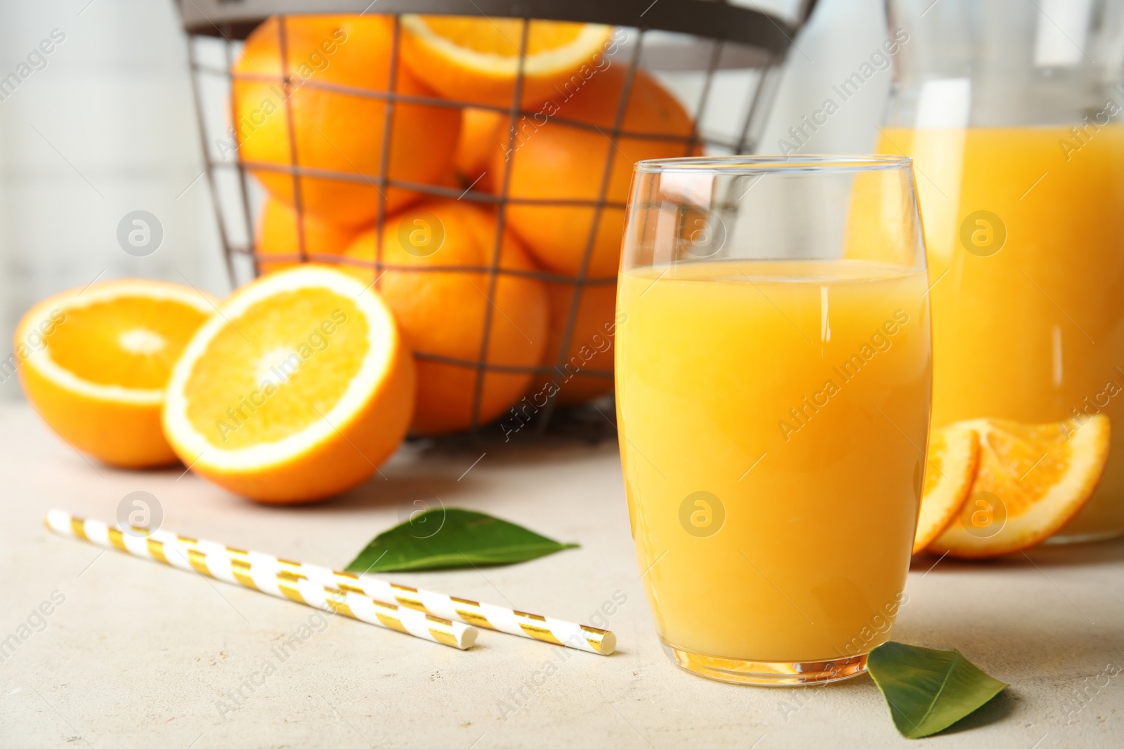 Photo of Composition with orange juice and fresh fruit on table, space for text