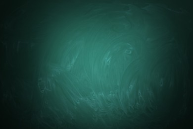 Dirty green chalkboard as background. Vignette effect