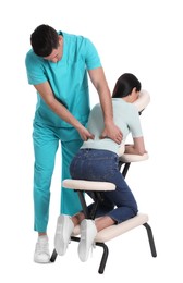 Photo of Woman receiving massage in modern chair on white background