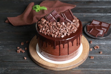 Freshly made delicious chocolate cake on black wooden table