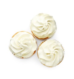 Tasty vanilla cupcakes with cream isolated on white, top view