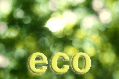 Image of Word ECO on blurred green background. Bokeh effect