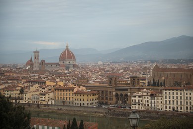 Florence, Italy - February 8, 2024: Picturesque view of city with beautiful buildings and mointains