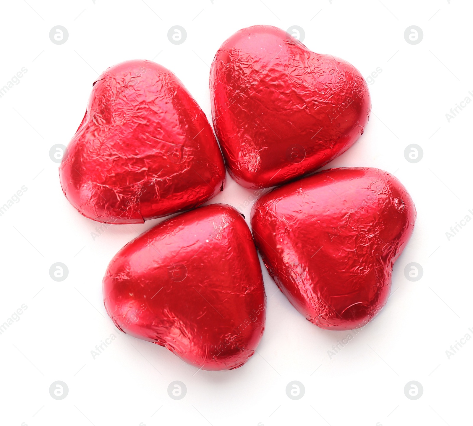 Photo of Heart shaped chocolate candies in red foil on white background, top view