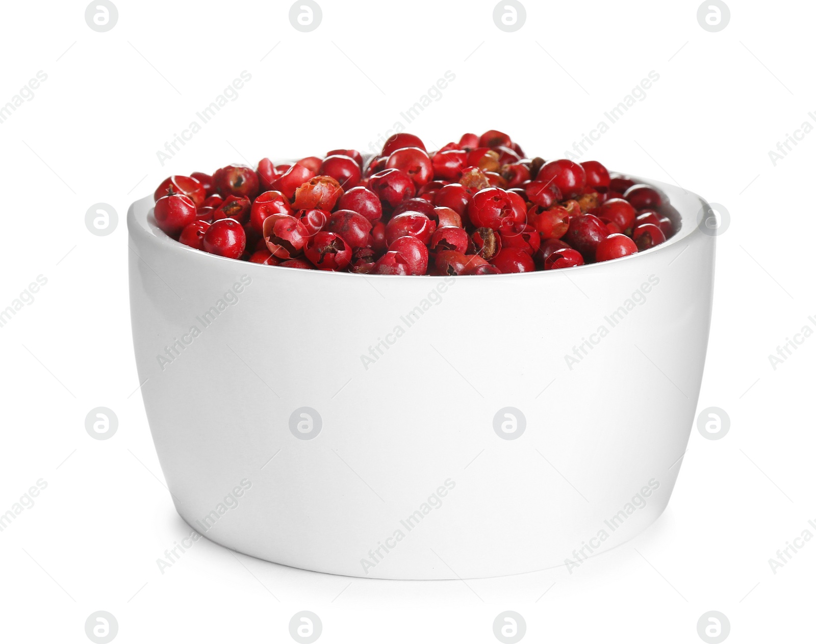 Photo of Bowl of red peppercorns isolated on white