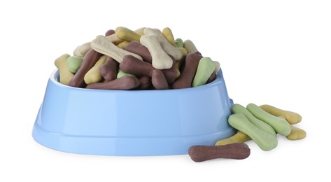 Photo of Different bone shaped dog cookies and feeding bowl on white background