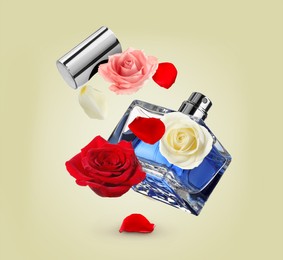 Bottle of perfume and roses in air on pale yellow background. Flower fragrance