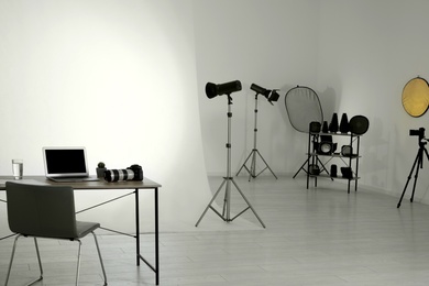 Photo of Photo studio interior with set of professional equipment and workplace