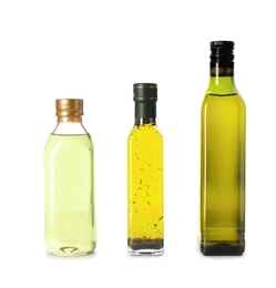 Glass bottles with different oils on white background