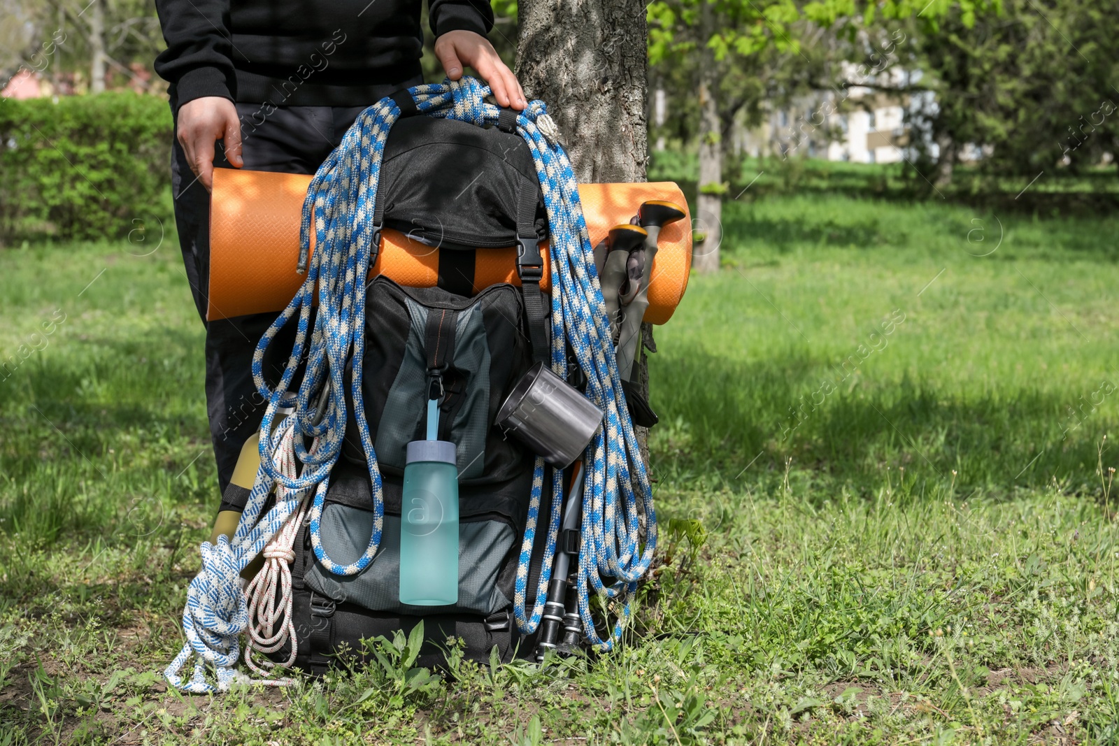 Photo of Hiker with backpack ready for journey in park, closeup