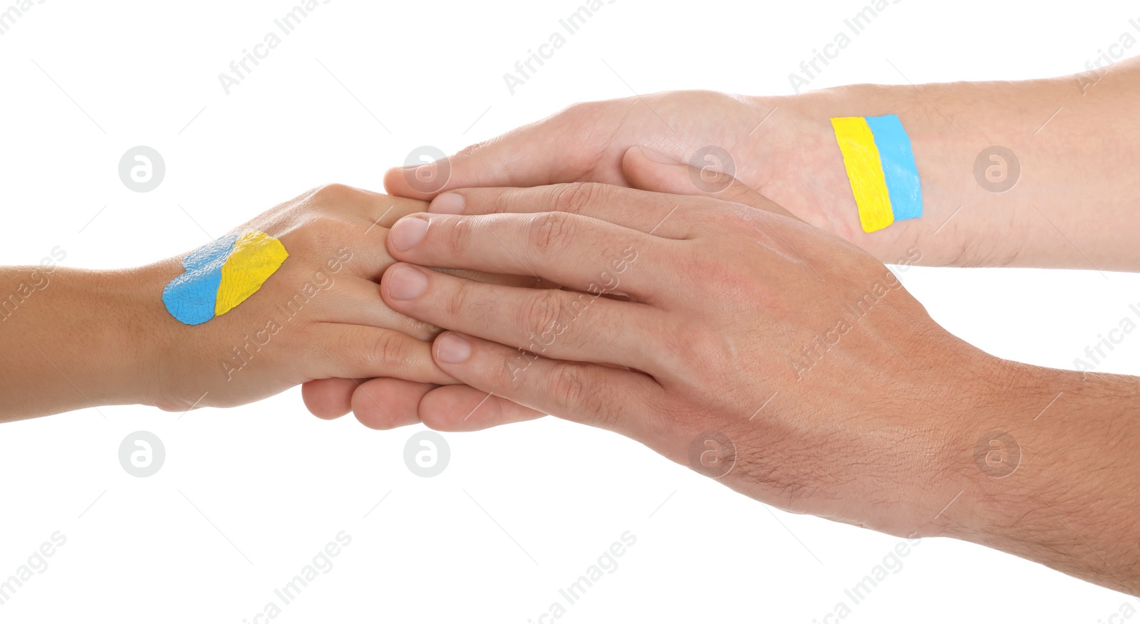 Photo of Man and woman with painted Ukrainian flags on their hands against white background, closeup