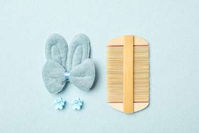 Flat lay composition with wooden hair comb on light background