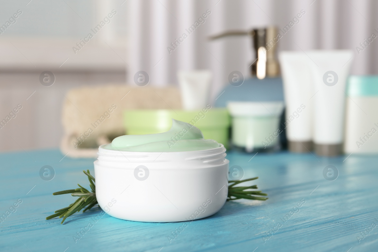 Photo of Jar of body care product on table against blurred background. Space for text