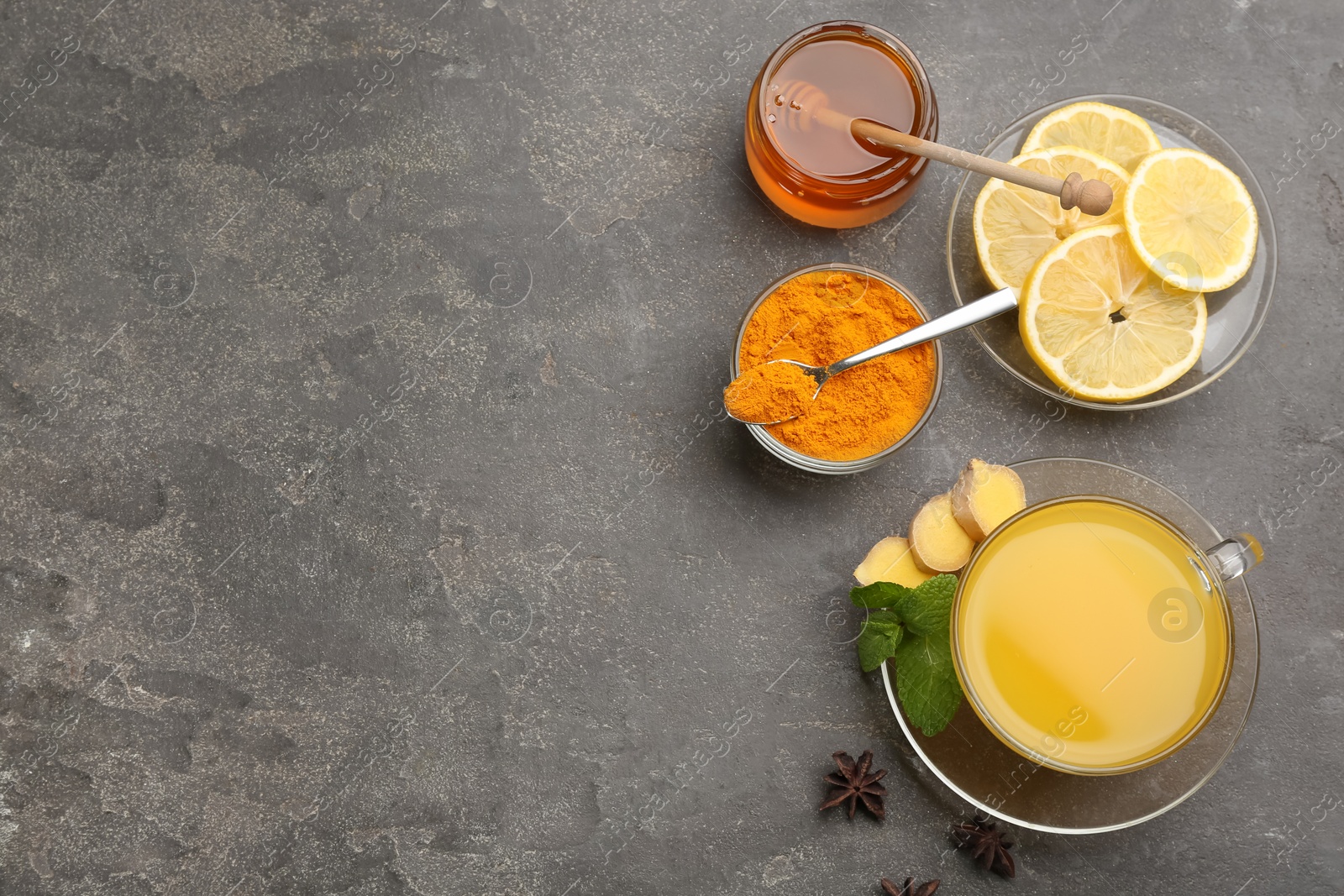 Photo of Flat lay composition with immunity boosting drink on grey table. Space for text