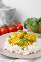 Photo of Delicious rice and chicken with curry sauce on white table, closeup