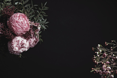 Photo of Beautiful fresh flowers on black background, space for text. Floral card design with dark vintage effect