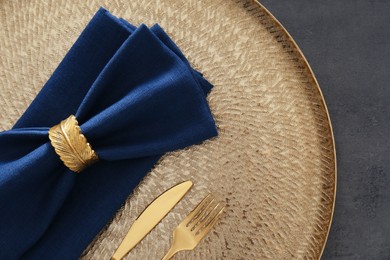 Photo of Tray with blue napkins, decorative ring and cutlery on grey table, top view