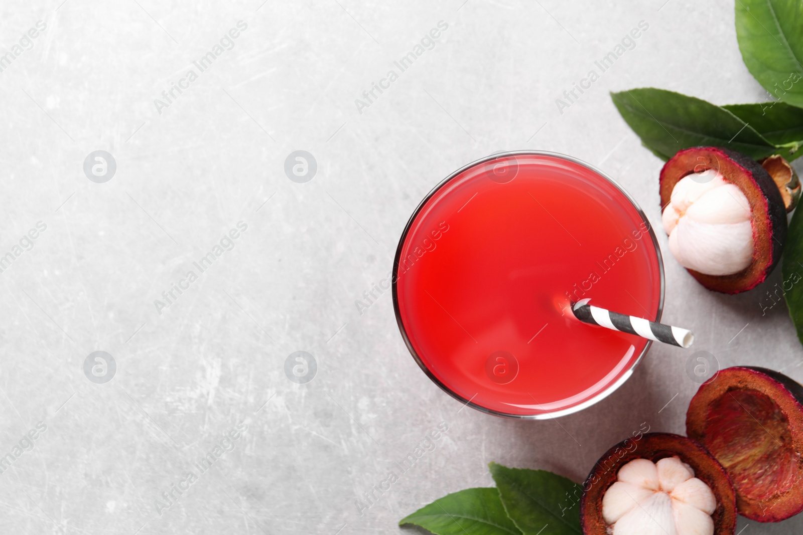 Photo of Delicious fresh mangosteen juice on table, flat lay. Space for text